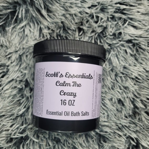 Container of Scott's Essentials Calm The Crazy Essential Oil Bath Salts on a textured gray surface
