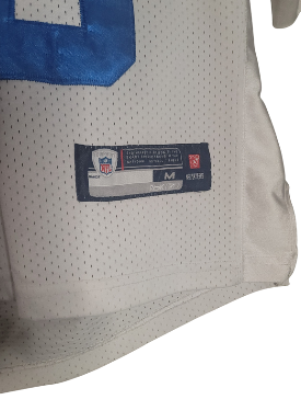 Close-up of Peyton Manning used youth medium jersey with an NFL label on a white background
