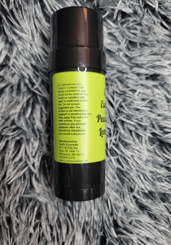 Peace, Love and Lemongrass bottle on a gray textured surface