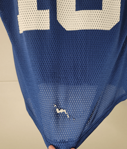Back of Peyton Manning jersey with small tear