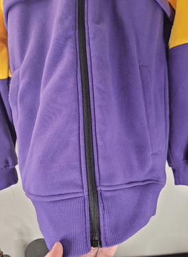 Los Angeles Lakers yellow and Purple jacket with a zipper on a neutral background