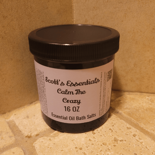 Jar of Scott's Essentials Calm The Crazy Essential Oil Bath Salts on a tiled surface.