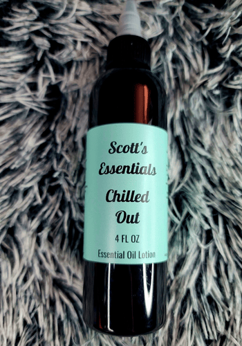 Bottle of Scott's Essentials Chilled Out essential oil lotion on a textured surface