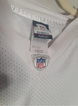 Close-up of an NFL jersey with a tag on a white background
