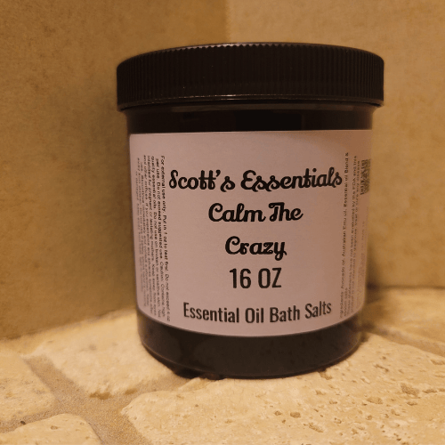 Jar of Scott's Essentials Calm The Crazy Essential Oil Bath Salts on a stone surface.