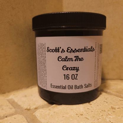 Jar of Scott's Essentials Calm The Crazy Essential Oil Bath Salts on a stone surface.
