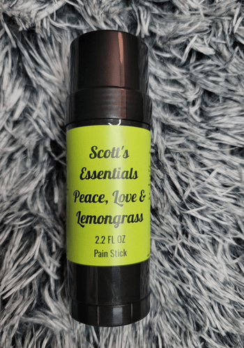 Pain stick labeled 'Scott's Essentials Peace, Love & Lemongrass' on a textured gray background