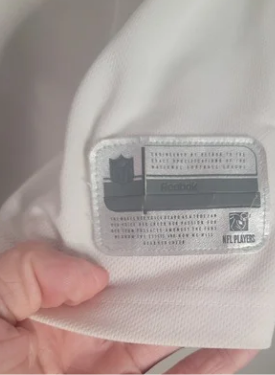 Close-up of Reebok label held by a hand