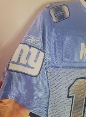 Blue NFL jersey with a logo and number on a plain background